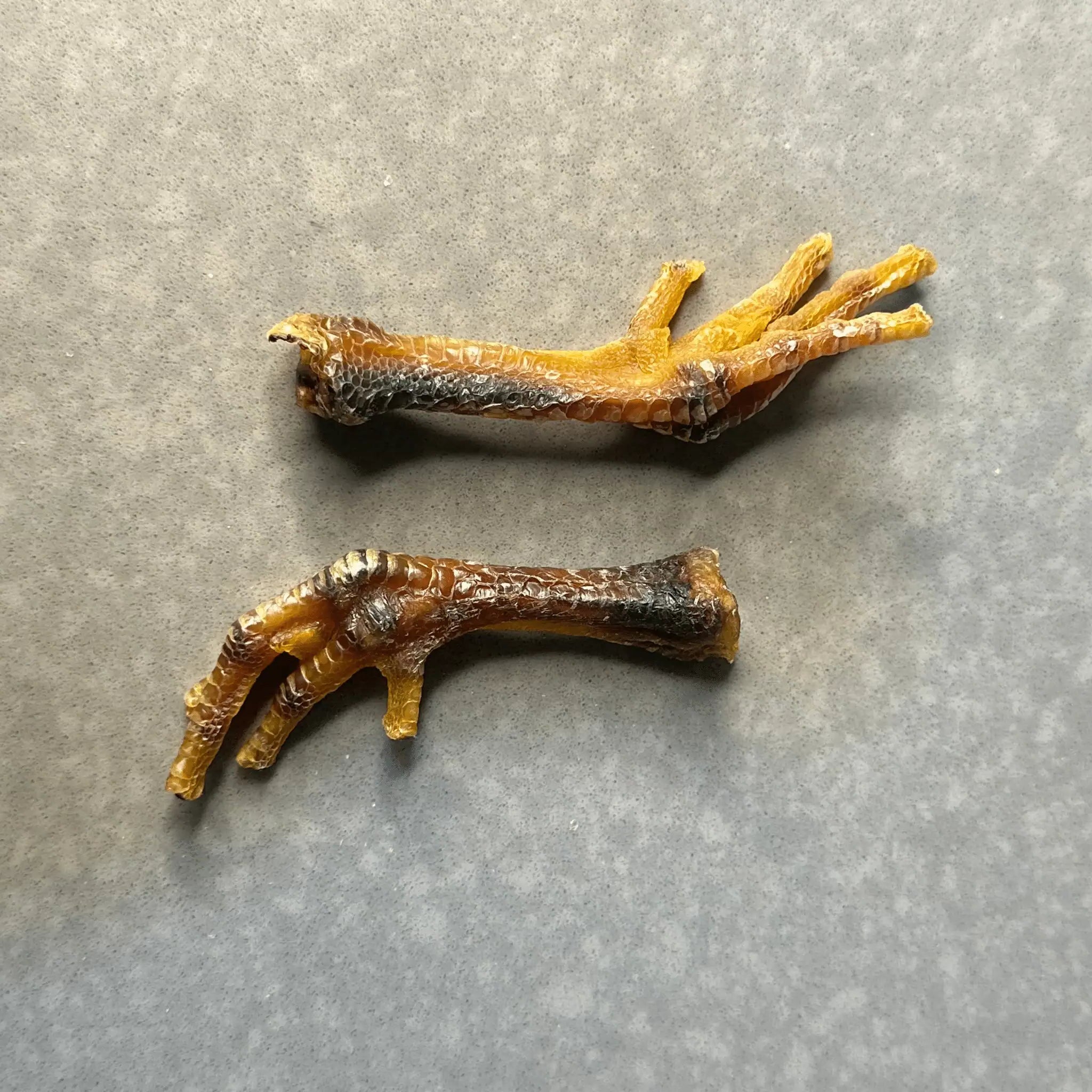 3nhalf dehydrated chicken feet dog treats placed side by side