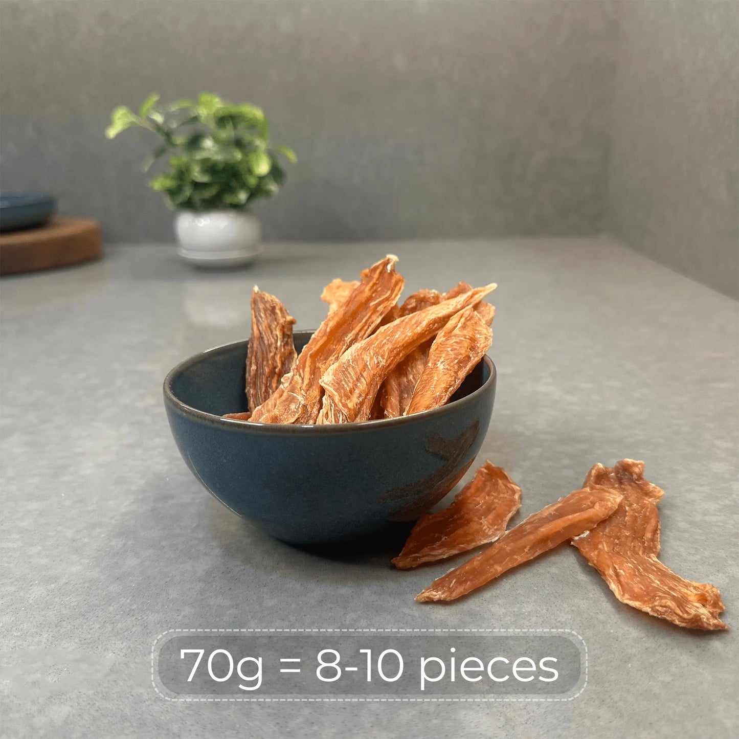 Bowl with 8–10 pieces of dehydrated chicken jerky dog treats showing 70g portion per pack