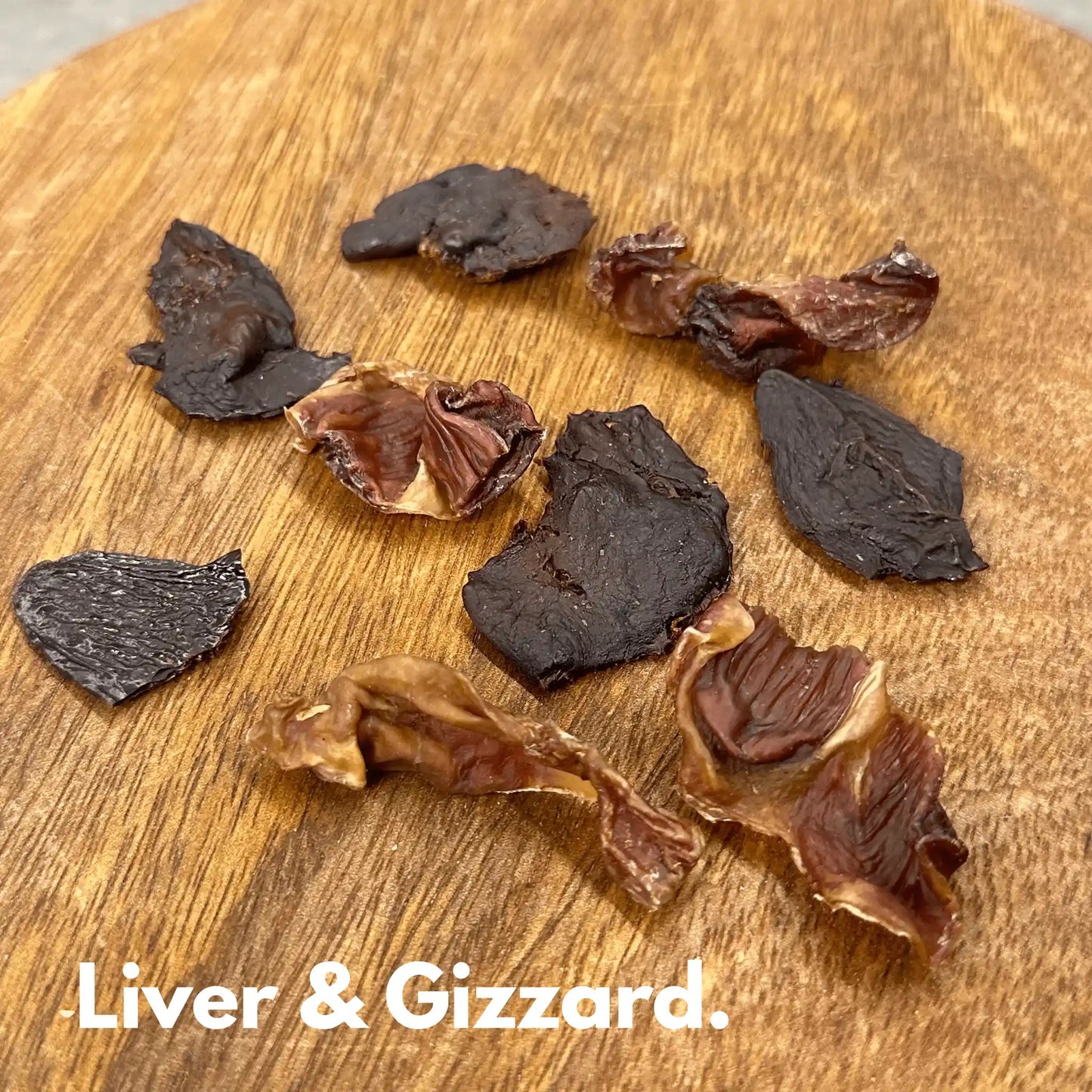 dehydrated chicken liver and gizzard dog treats on wooden surface